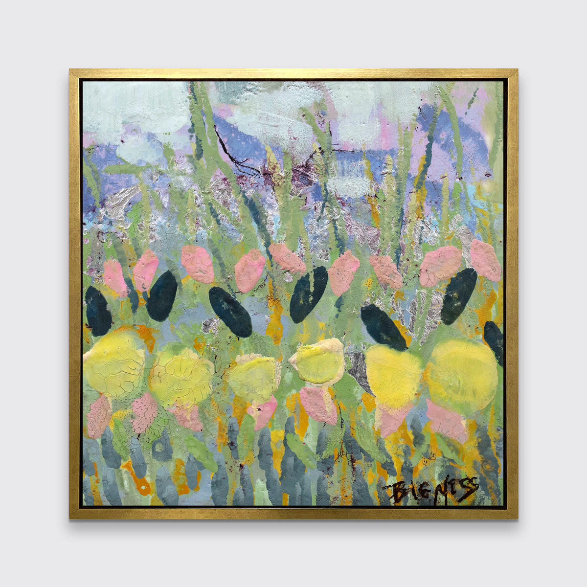 A green, yellow and pink abstract floral print in a gold floater frame hangs on a white wall.