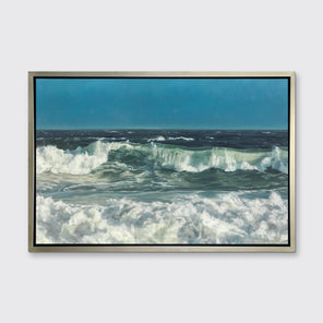 A blue, green and white abstract ocean waves print in a silver floater frame hangs on a white wall.