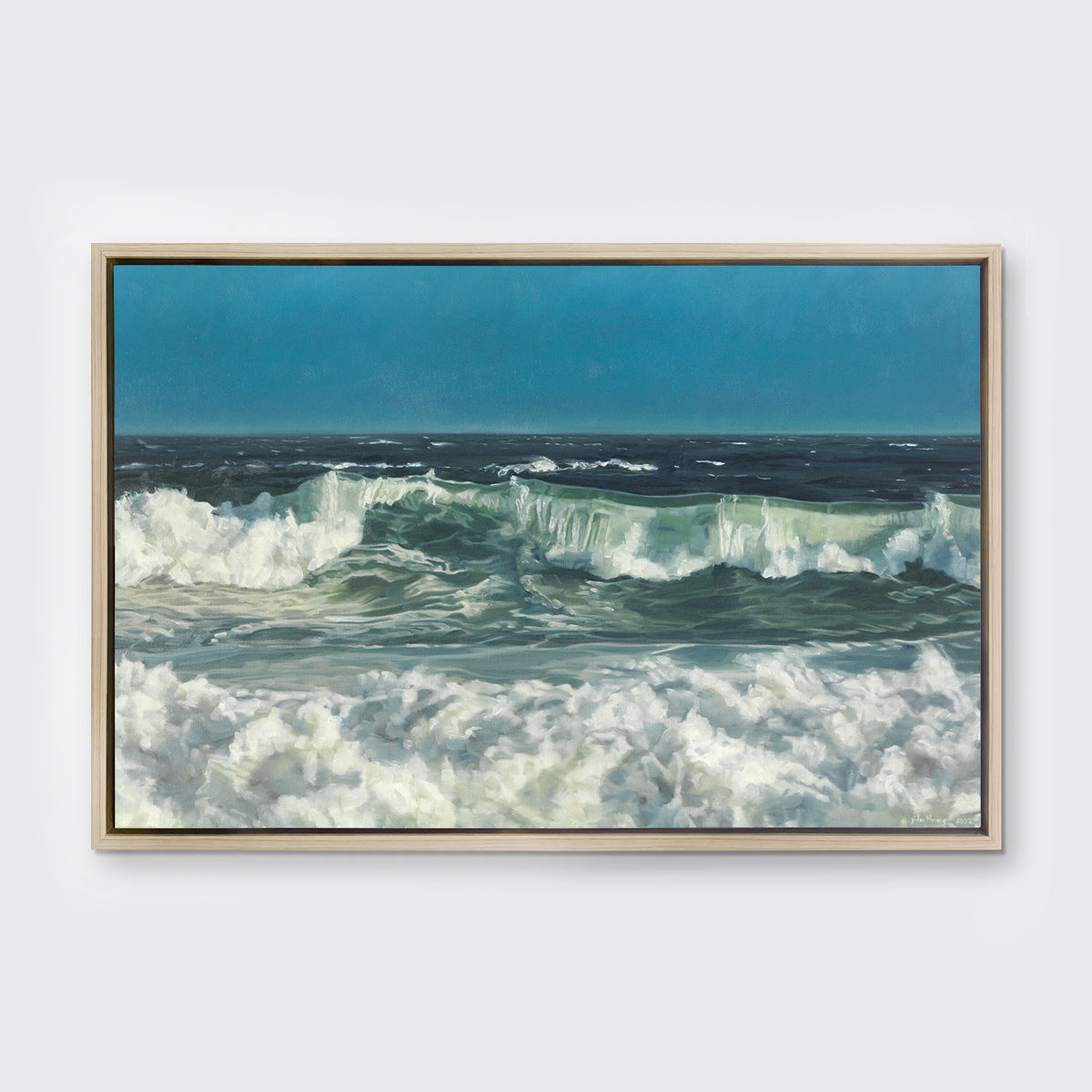 A blue, green and white abstract ocean waves print in a white oak wood floater frame hangs on a white wall.