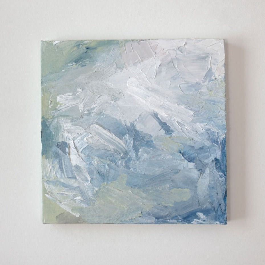 A painting is hanging on a wall. Its surface is decorated with white, blue and green paint in a thick impasto. Wired and ready to hang.