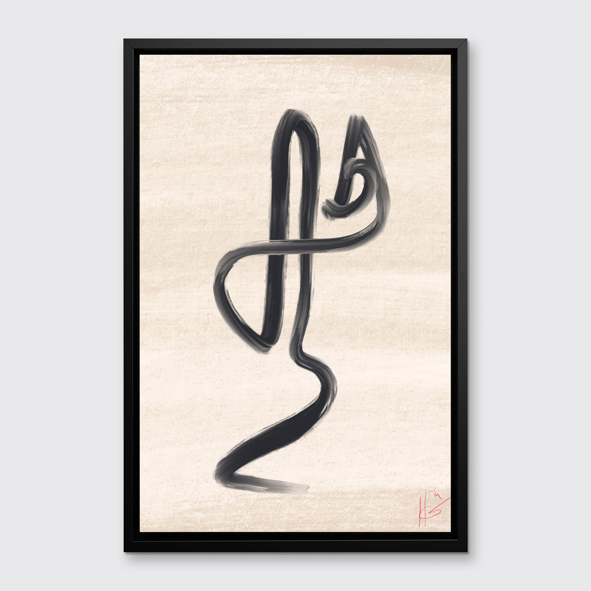 A black and beige abstract print framed in a black floater frame hangs on a light grey wall.