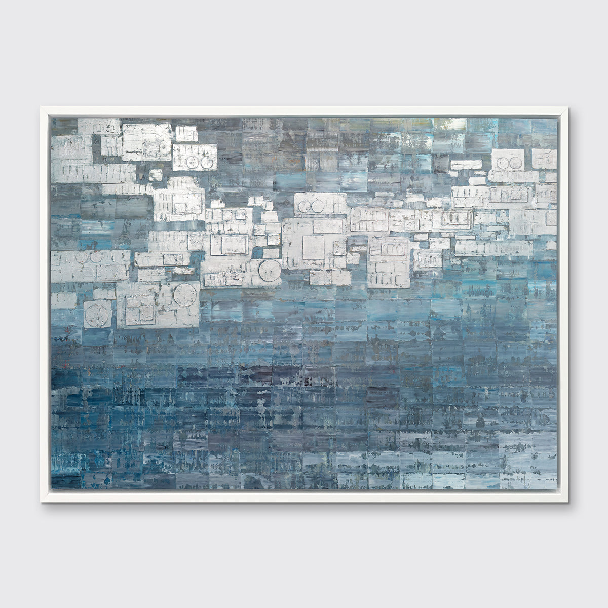 A blue, white and grey abstract print in a white floater frame hangs on a white wall.
