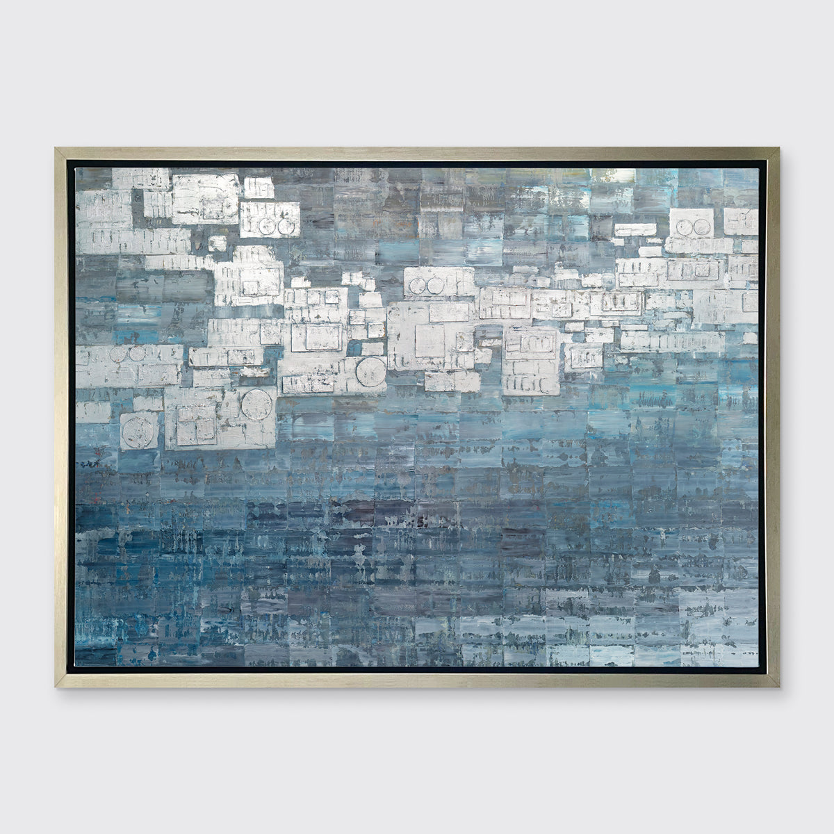 A blue, white and grey abstract print in a silver floater frame hangs on a white wall.