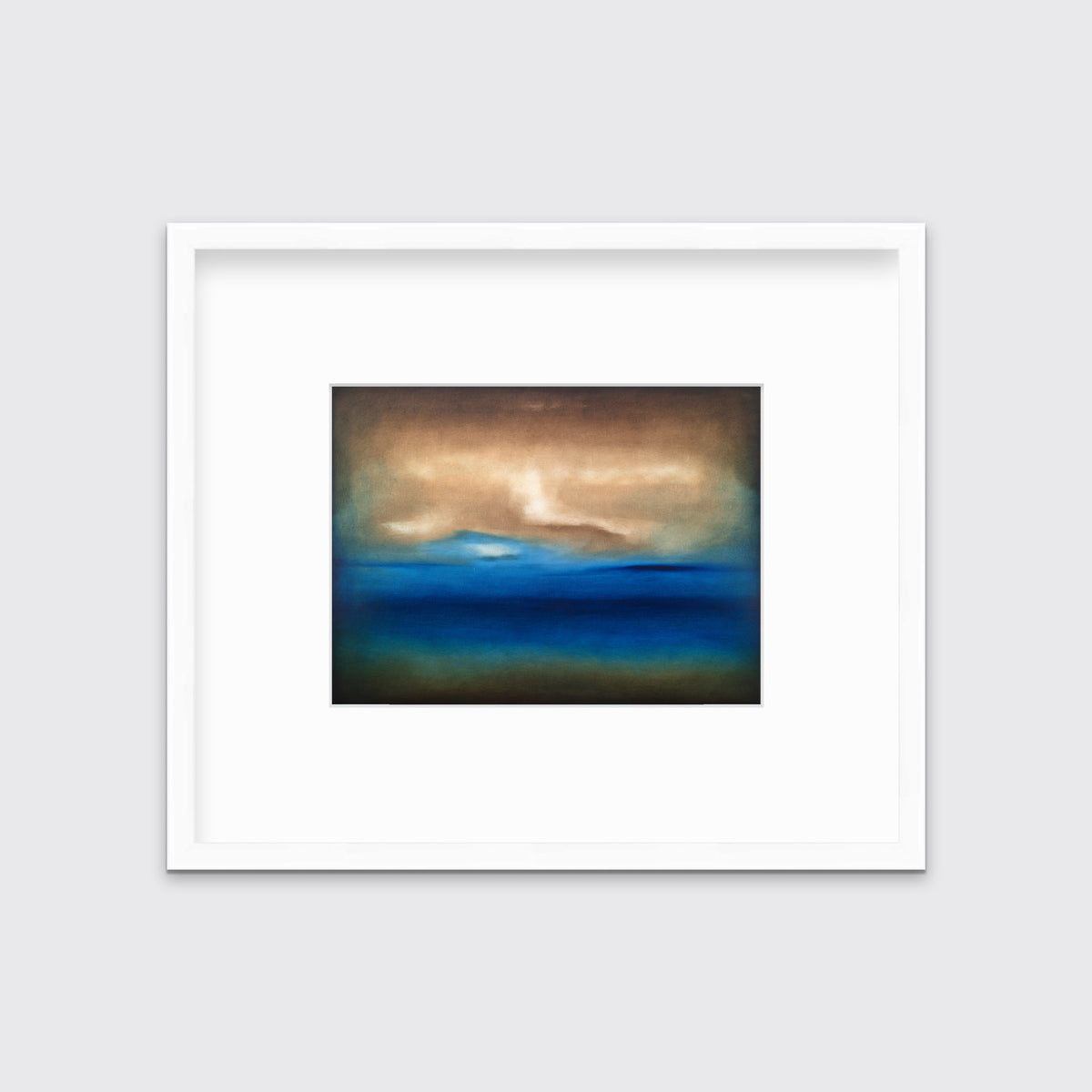 A dark brown, blue, white and teal abstract landscape print in a white frame with a mat hangs on a white wall.