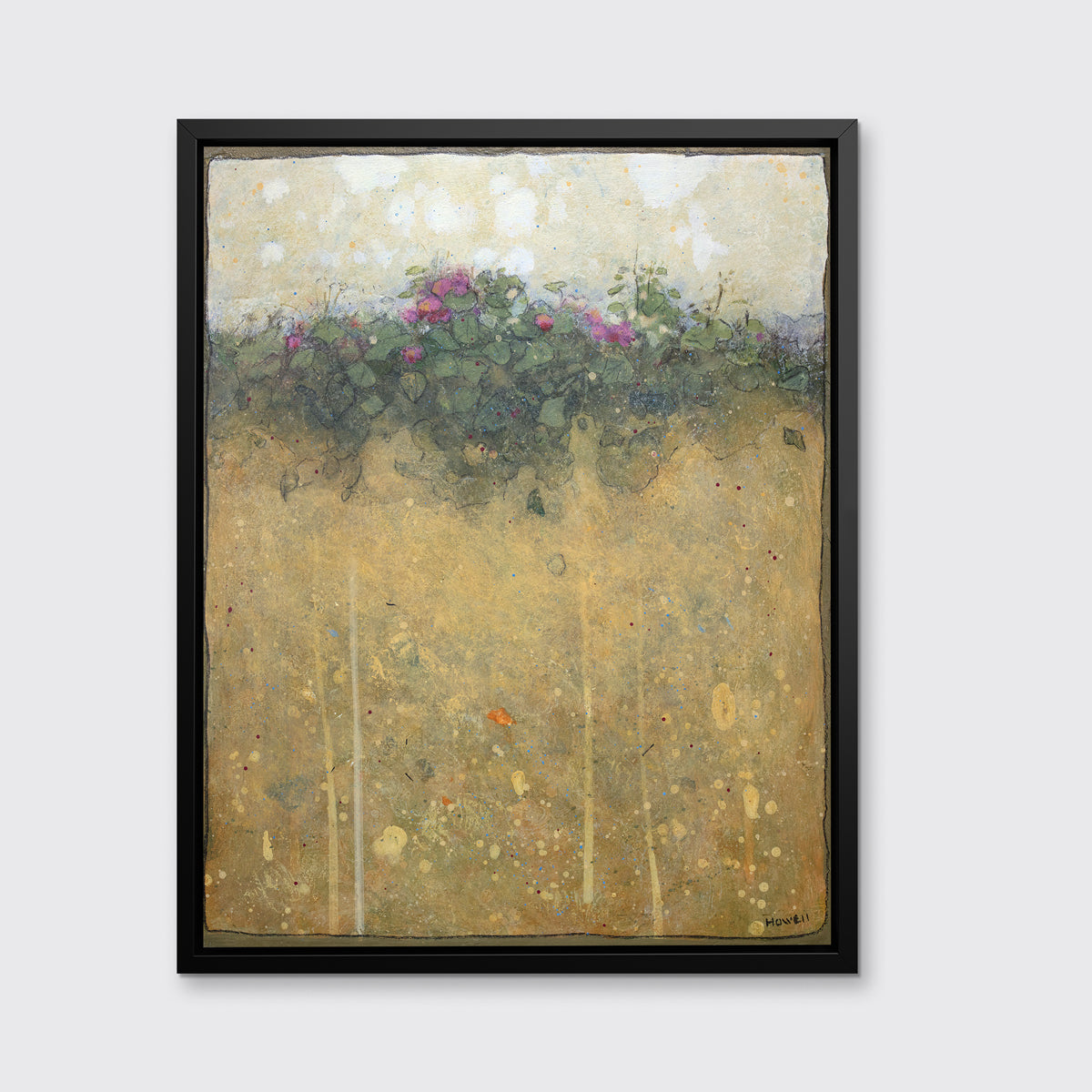A dark yellow, green and beige abstract landscape print in a black floater frame hangs on a white wall.
