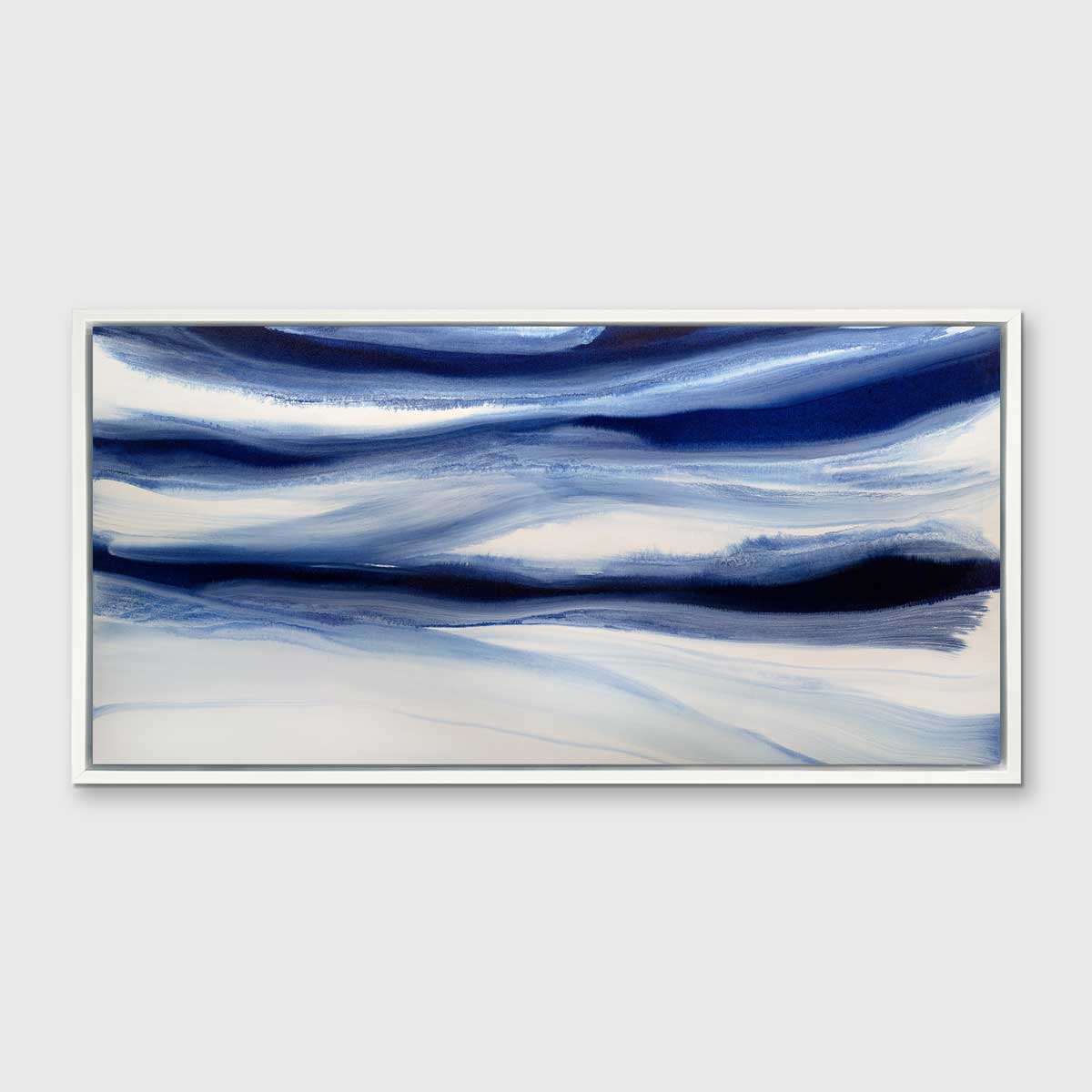 A dark blue and white abstract print in a white floater frame hangs on a white wall.