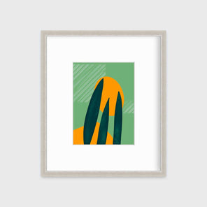An abstract print of a green desert plant in front of light green and orange organic shapes with square white linear lines in a silver frame with a mat hangs on a white wall.