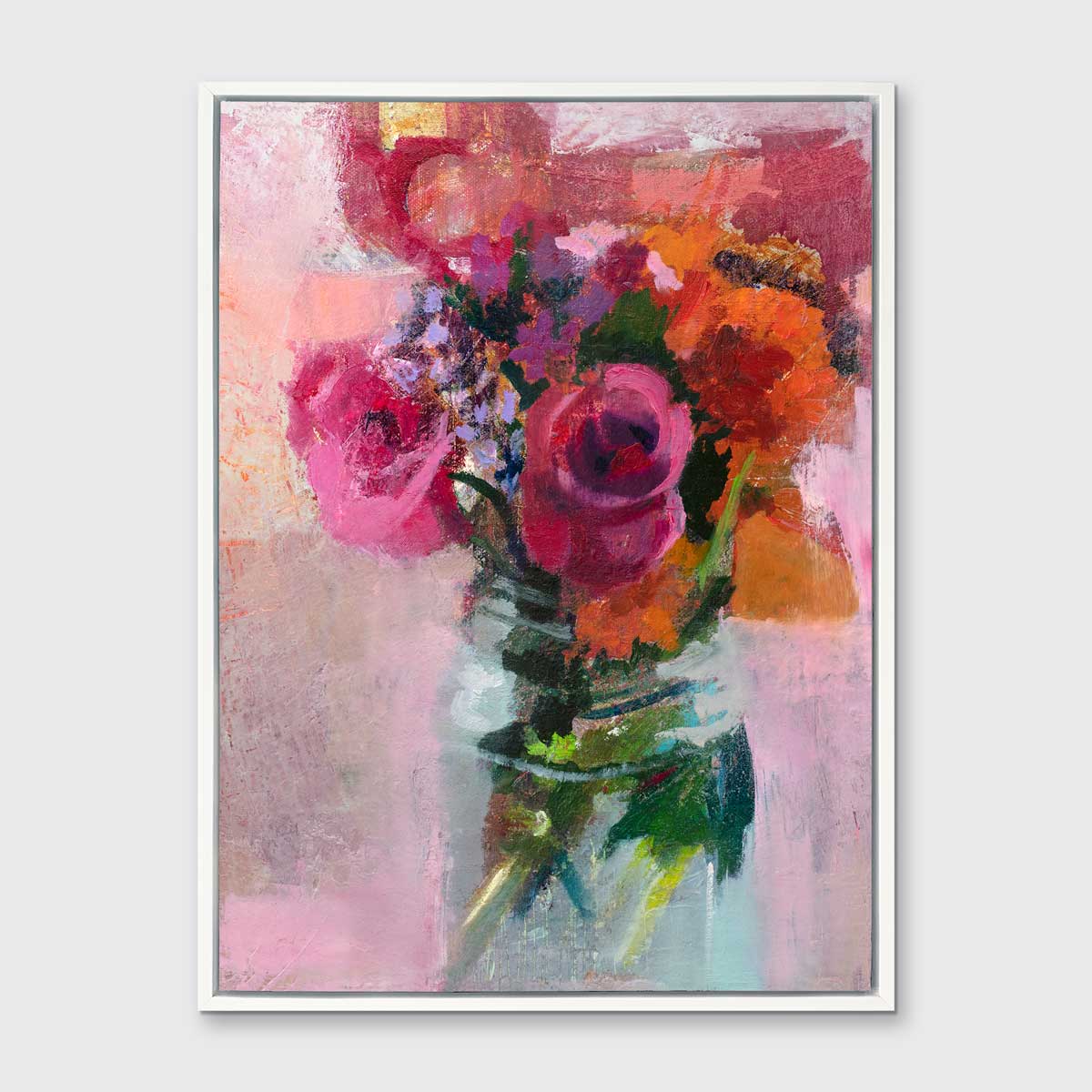 A pink, orange and green abstract floral print in a white floater frame hangs on a white wall.