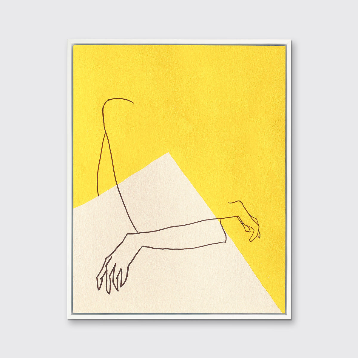 A yellow and white abstract print by Hazal Ozturk in a white floater frame hangs on a white wall.
