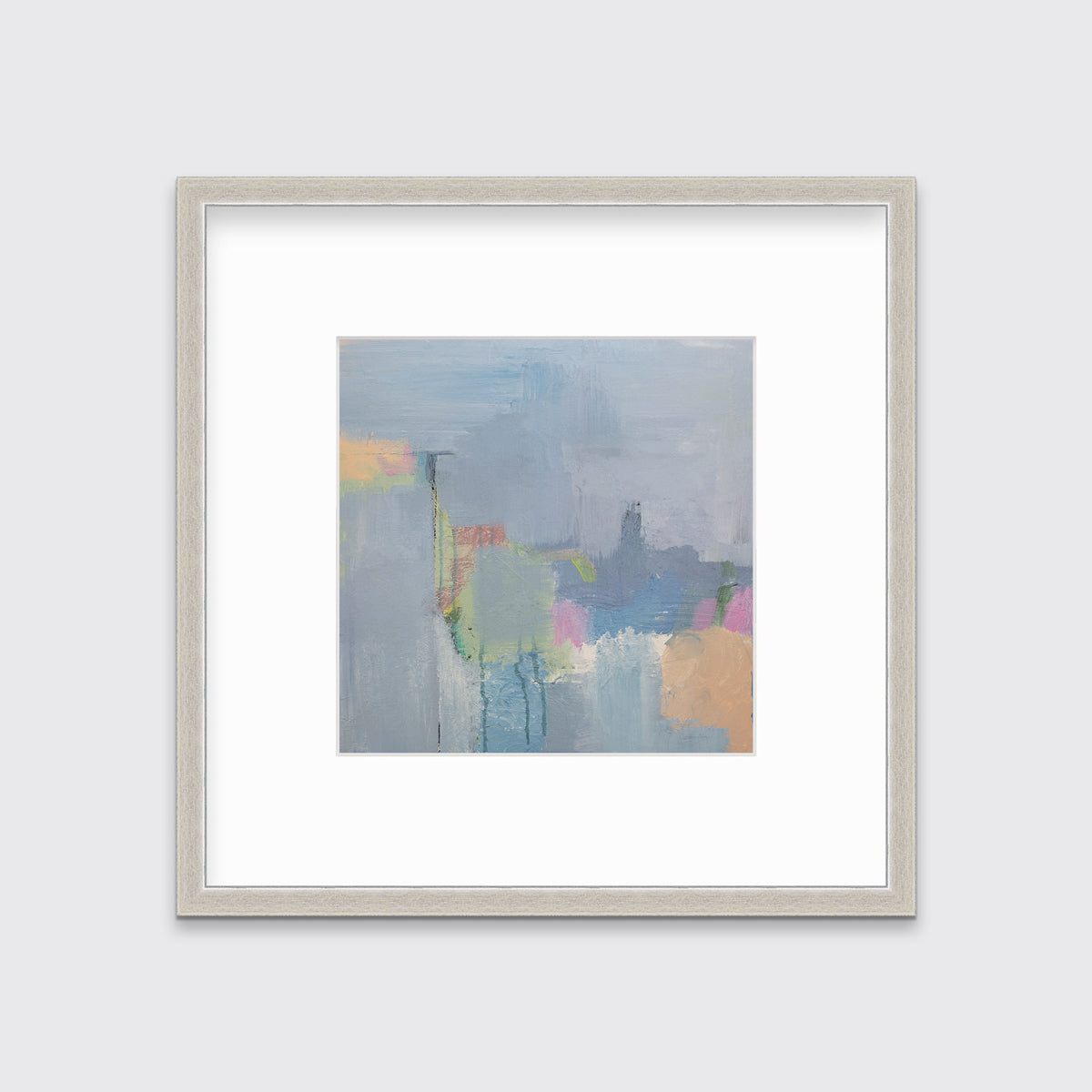 A slate blue, green, light orange and pink abstract print in a silver frame with a mat hangs on a white wall.