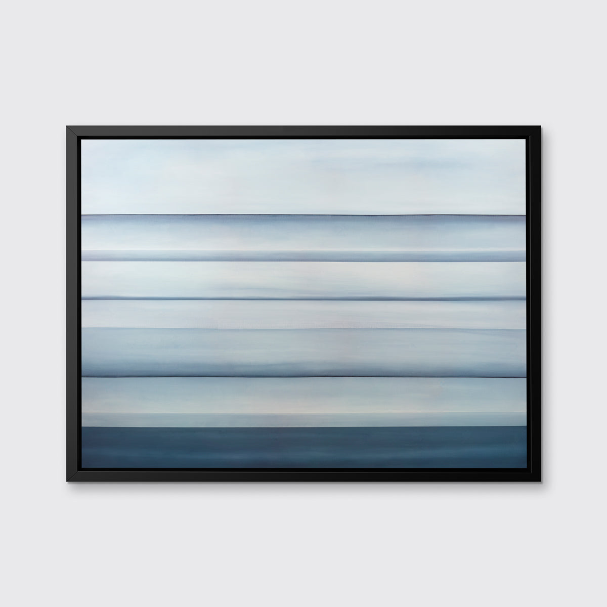 A tonal blue abstract landscape print in a black floater frame hangs on a white wall.