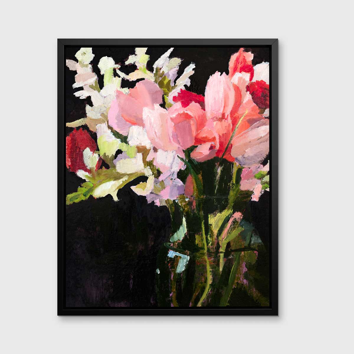 A pink, black and green abstract floral print in a black floater frame hangs on a white wall.