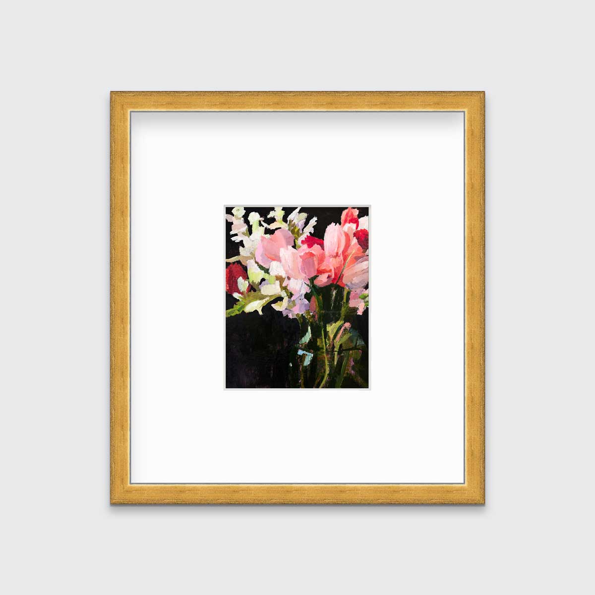 A pink, black and green abstract floral print in a gold frame with a mat hangs on a white wall.