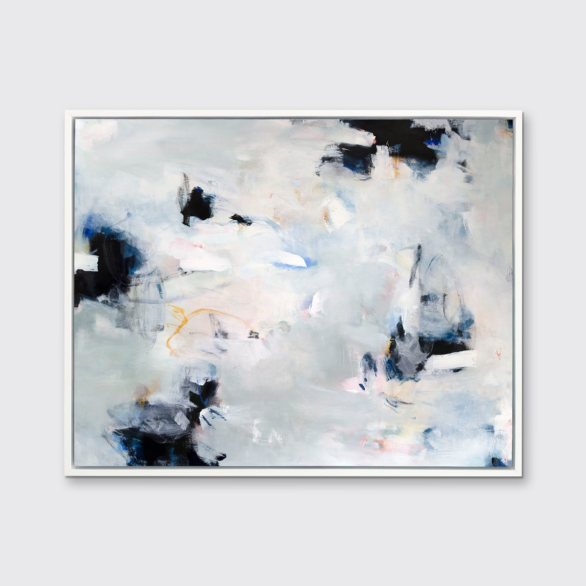 A white, black and grey abstract print in a white floater frame hangs on a white wall.