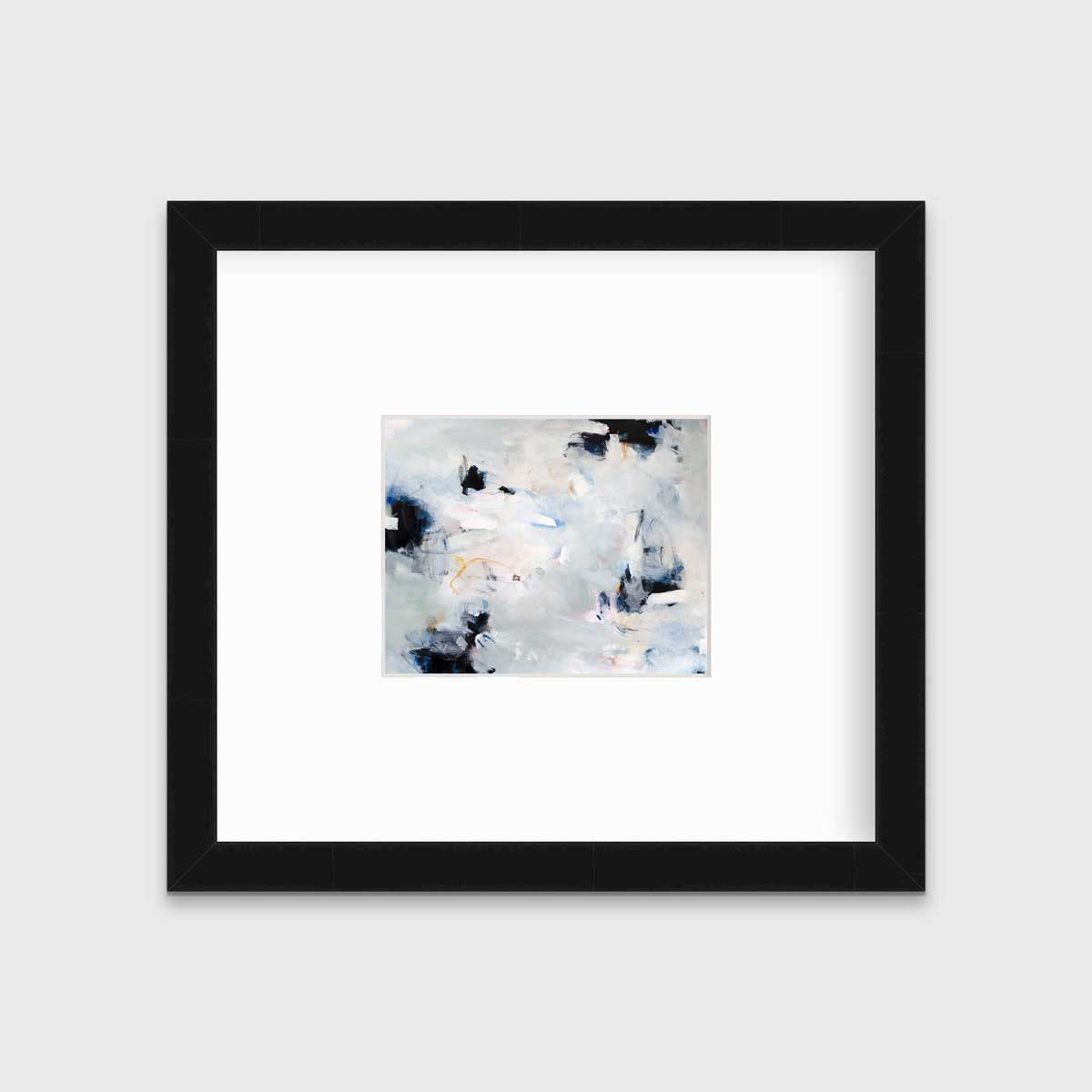 A black and white abstract print by Kelly Rossetti hangs in a black frame with a mat on a white wall.