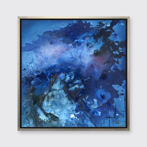A blue and black abstract print in a silver floater frame hangs on a white wall.