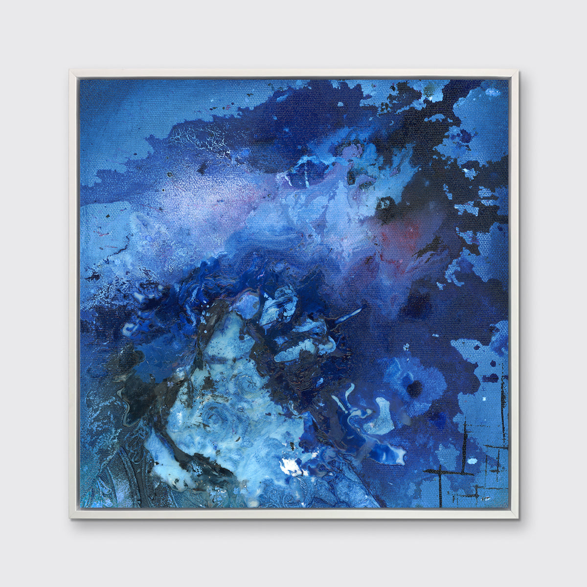 A blue and black abstract print in a white floater frame hangs on a white wall.
