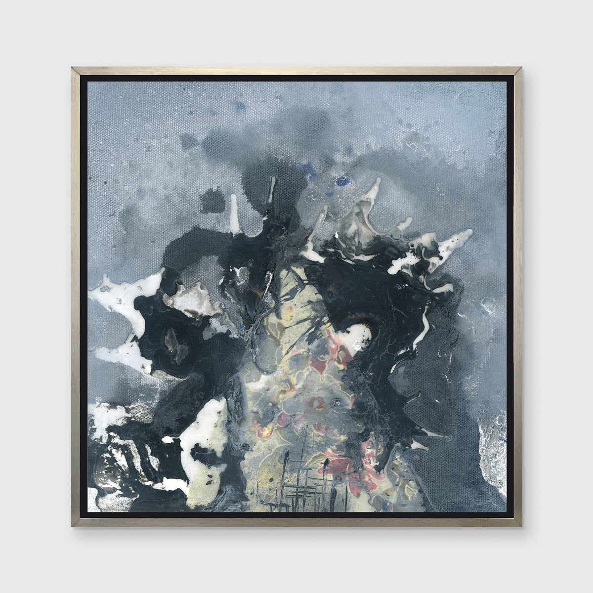 A grey, black, white and light yellow abstract print in a silver floater frame hangs on a white wall.