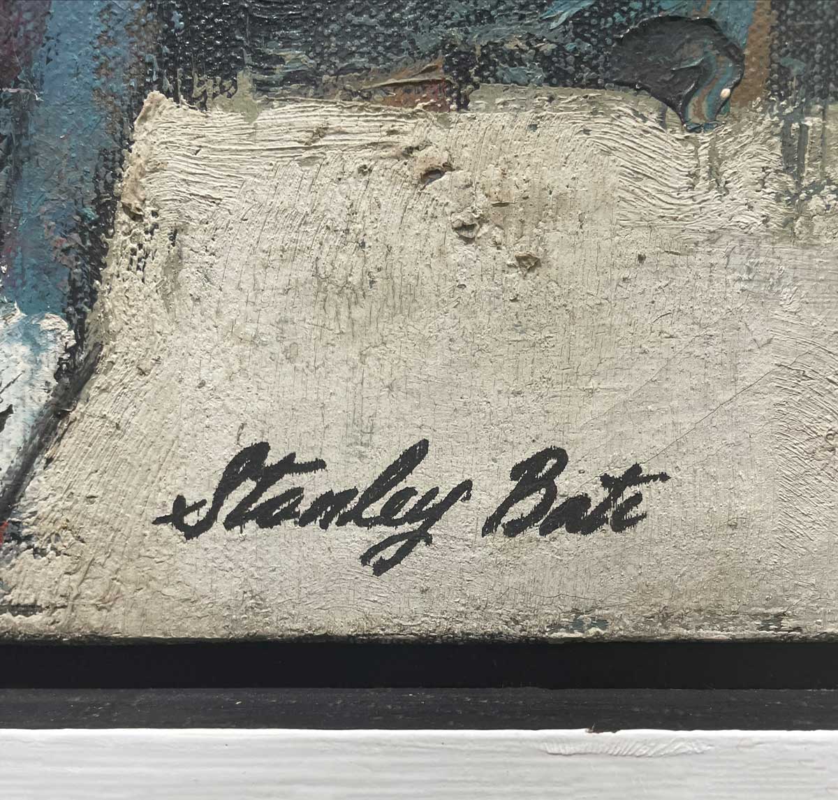 A close up of the artist's name in the lower right hand corner.