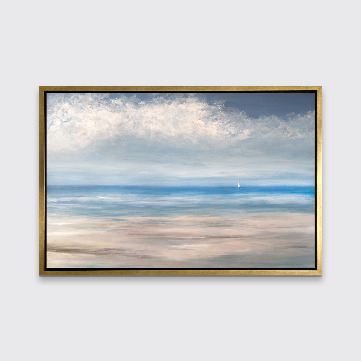 A blue, white and beige seascape print in a gold floater frame hangs on a white wall.