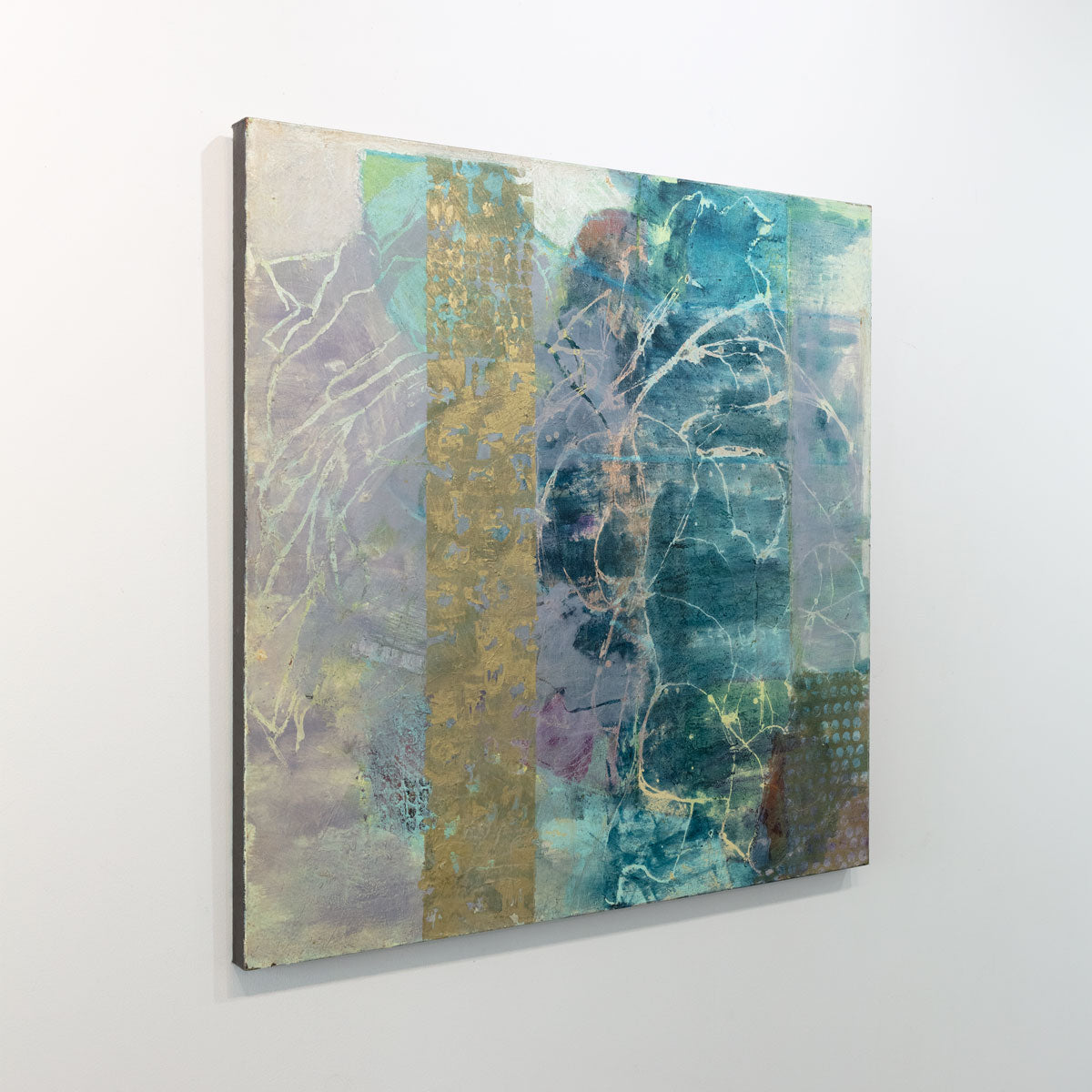 An abstract painting with turquoise, purple, and golden tones is seen at an angle on a gallery wall.