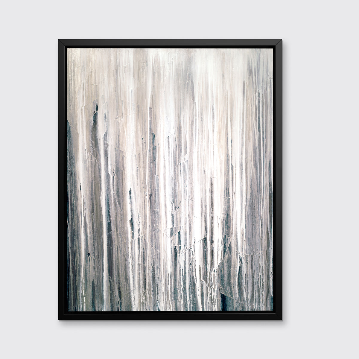 A white, cream and charcoal print in a black floater frame hangs on a white wall.