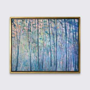 A multicolored abstract tree landscape print in a gold floater frame hangs on a white wall.