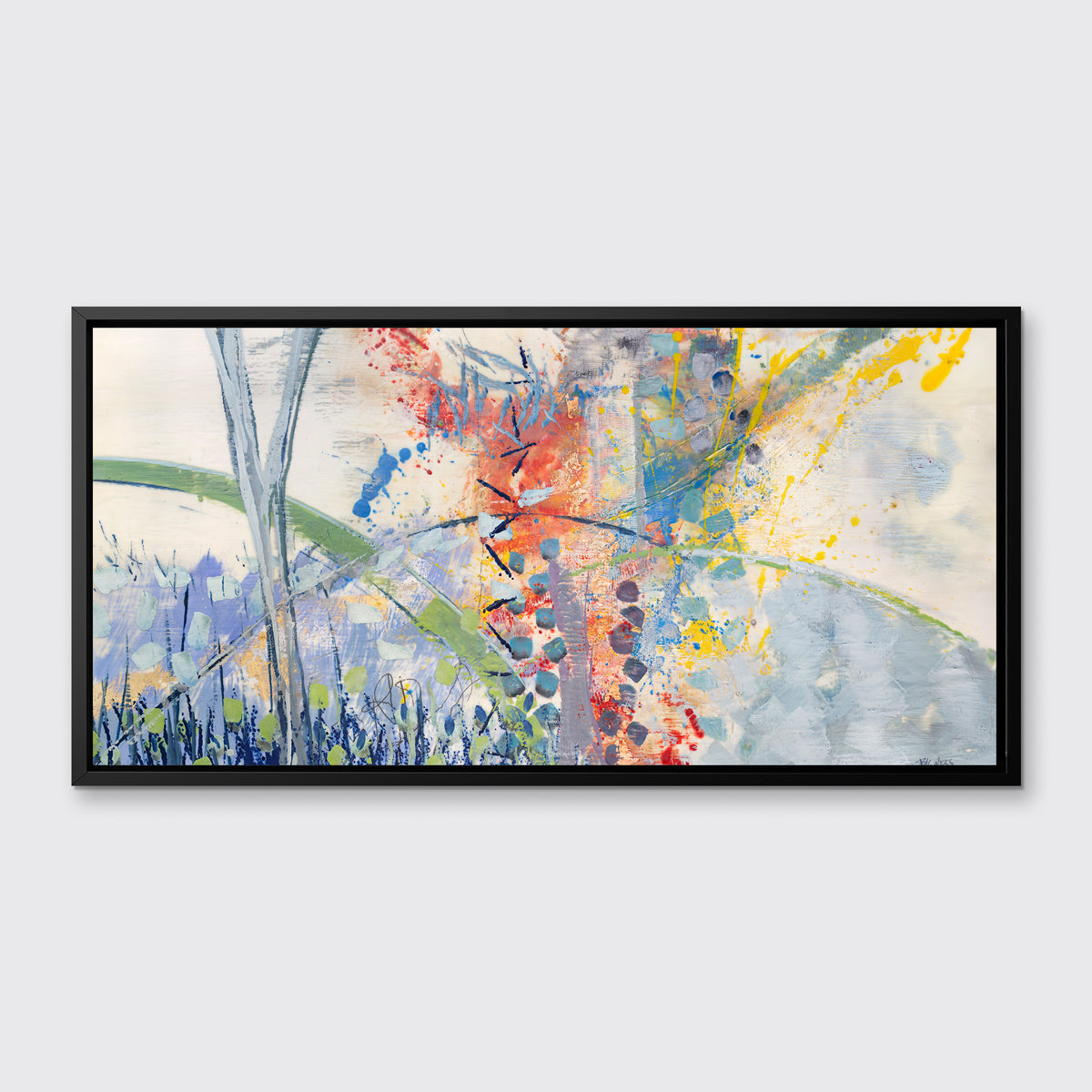 A multicolored abstract print in a black floater frame hangs on a white wall.