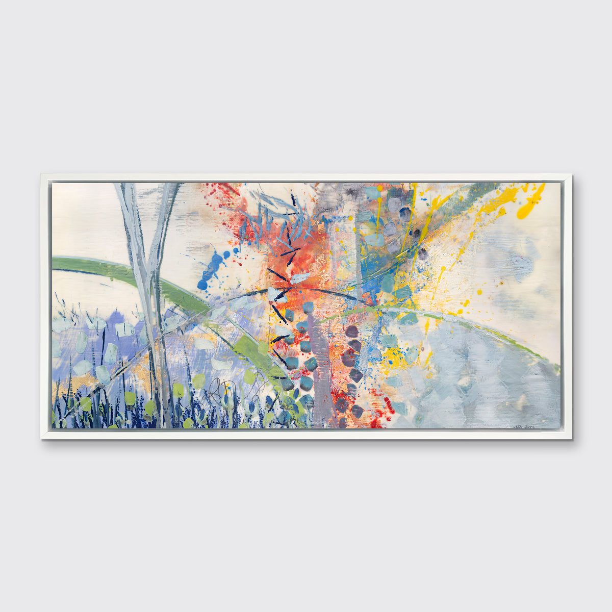 A multicolored abstract print in a white floater frame hangs on a white wall.