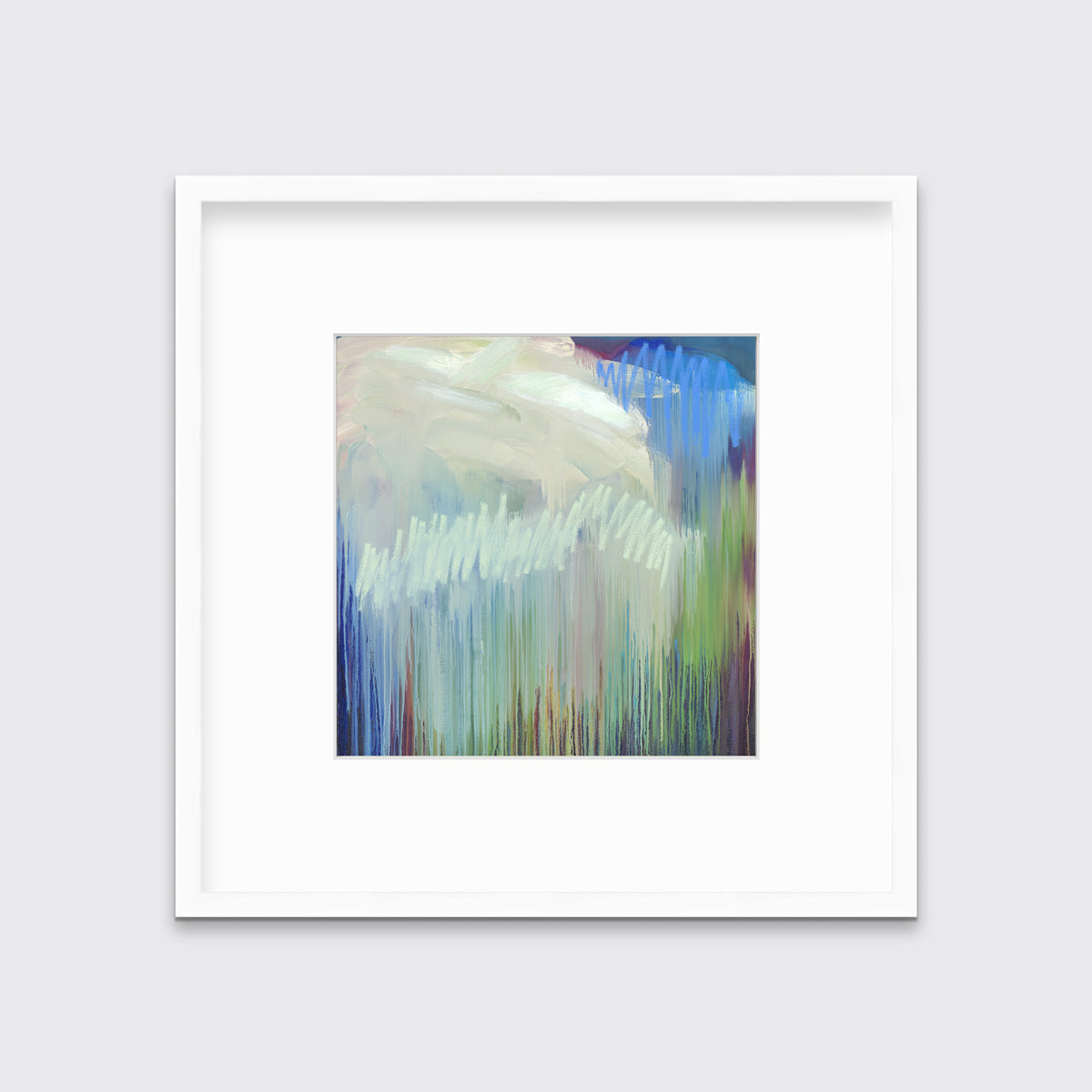 A multicolored abstract print in a white frame with a mat hangs on a white wall.