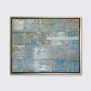 A blue and green abstract geometric print in a silver floater frame hangs on a white wall.