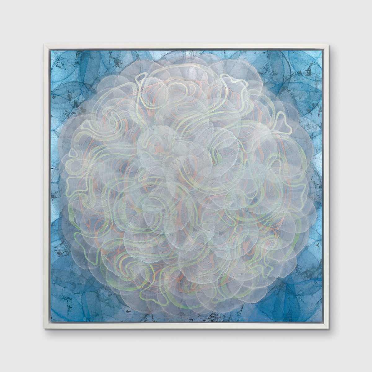 A blue, white, orange and yellow abstract geometric print in a white floater frame hangs on a white wall.