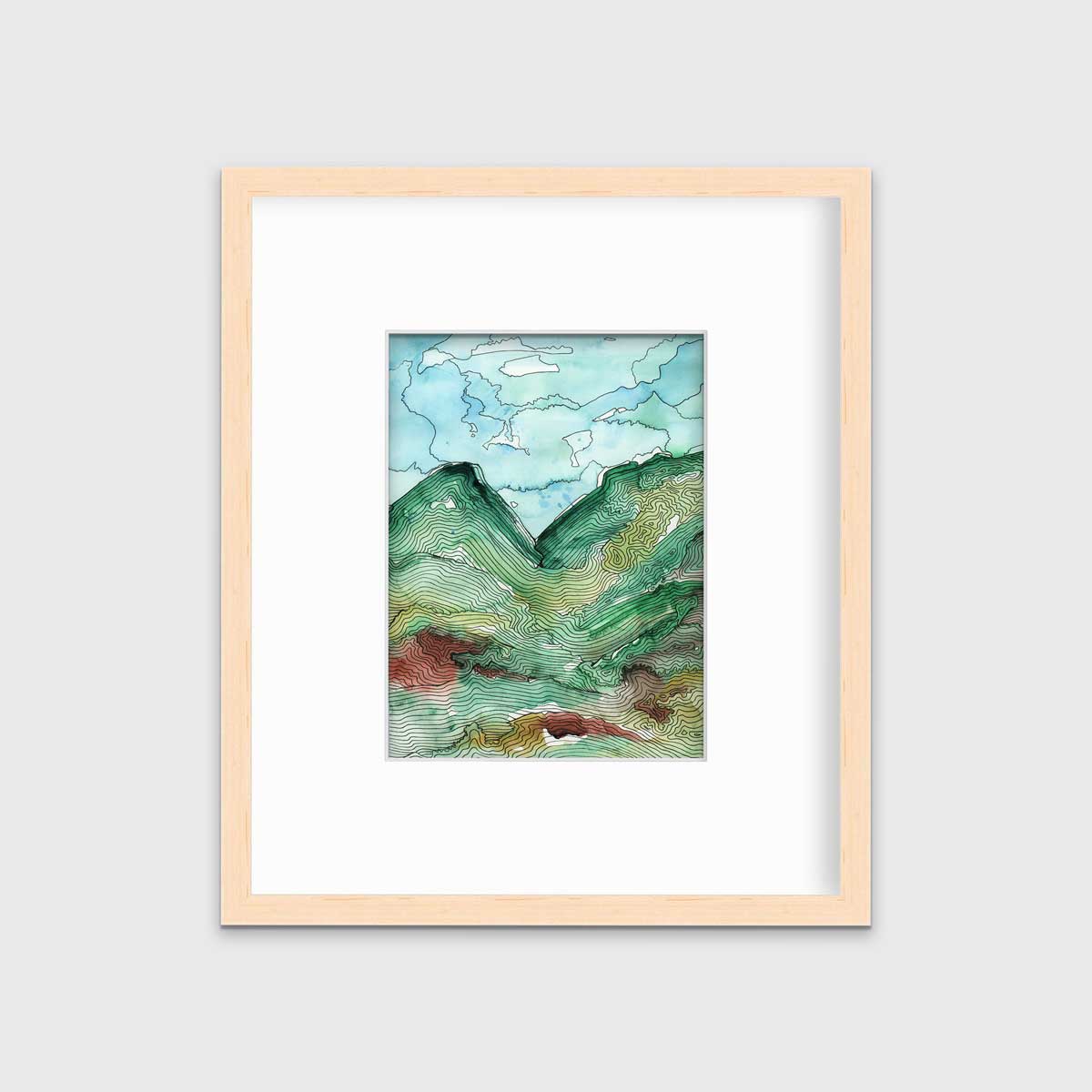 A blue, green and black abstract landscape print in a natural wood frame with a mat hangs on a white wall.