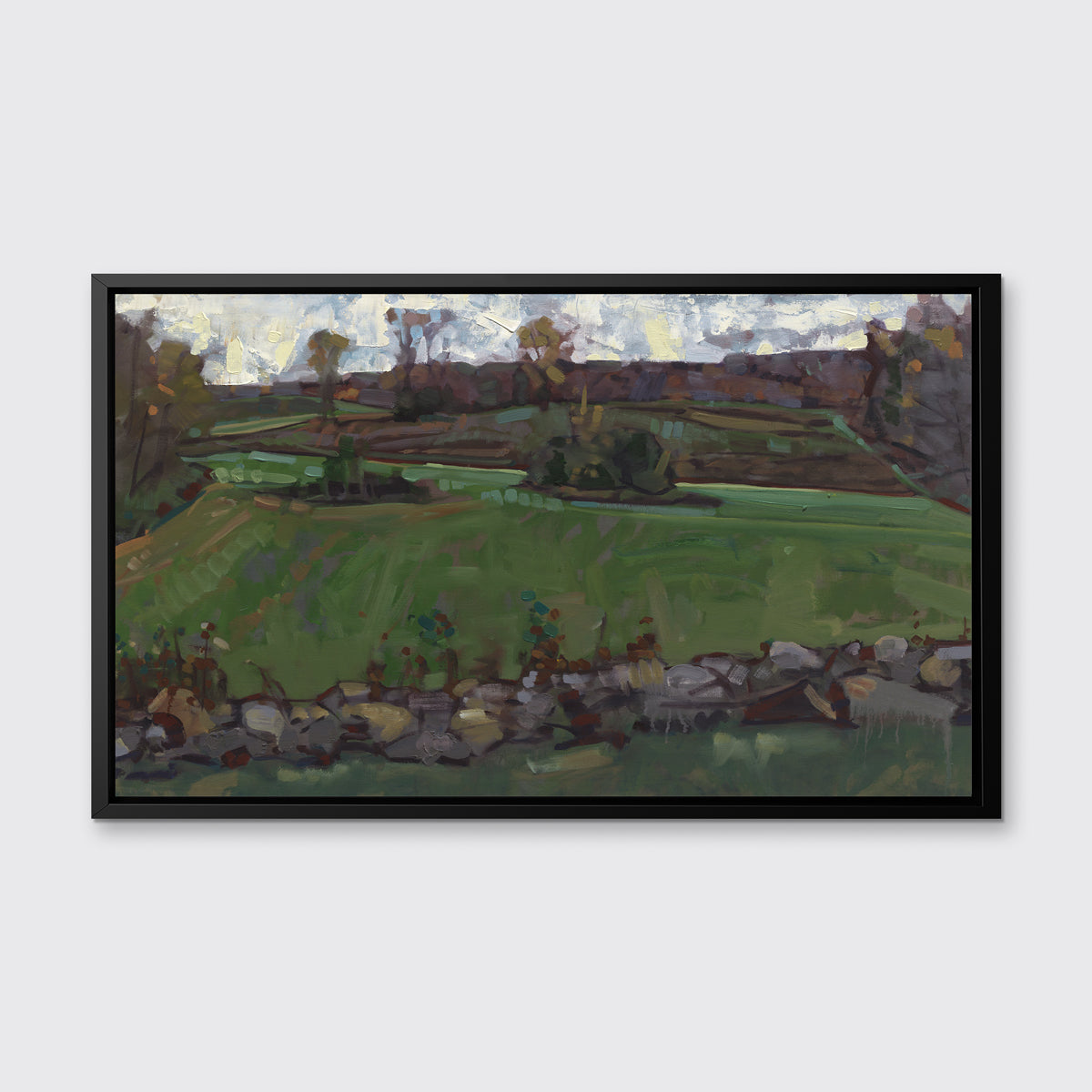 A green, brown and white abstract landscape print in a black floater frame hangs on white wall.
