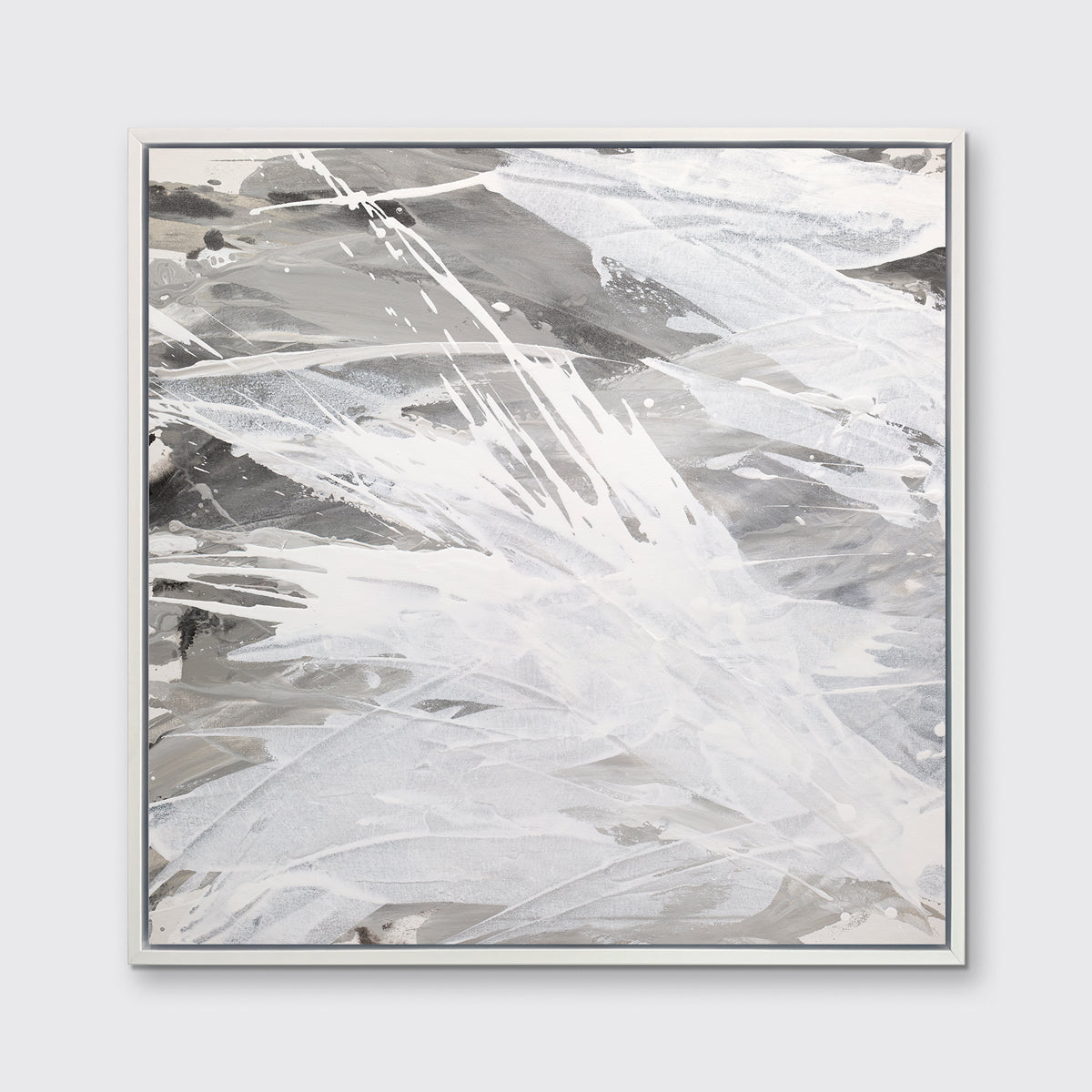 A grey, beige and white abstract print in a white floater frame hangs on a white wall.