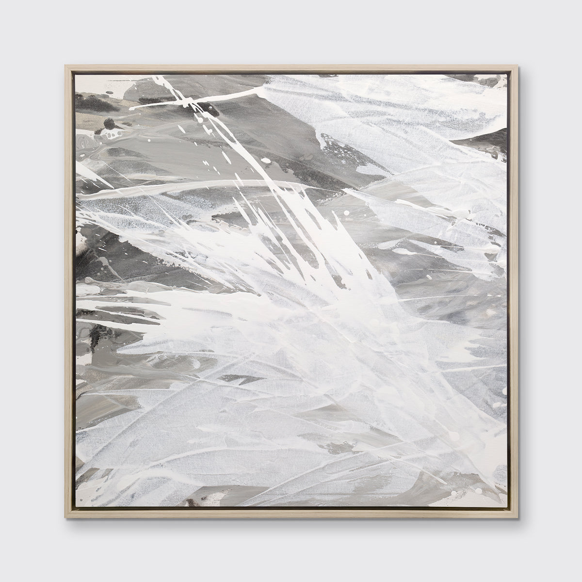 A grey, beige and white abstract print in a white oak wood floater frame hangs on a white wall.
