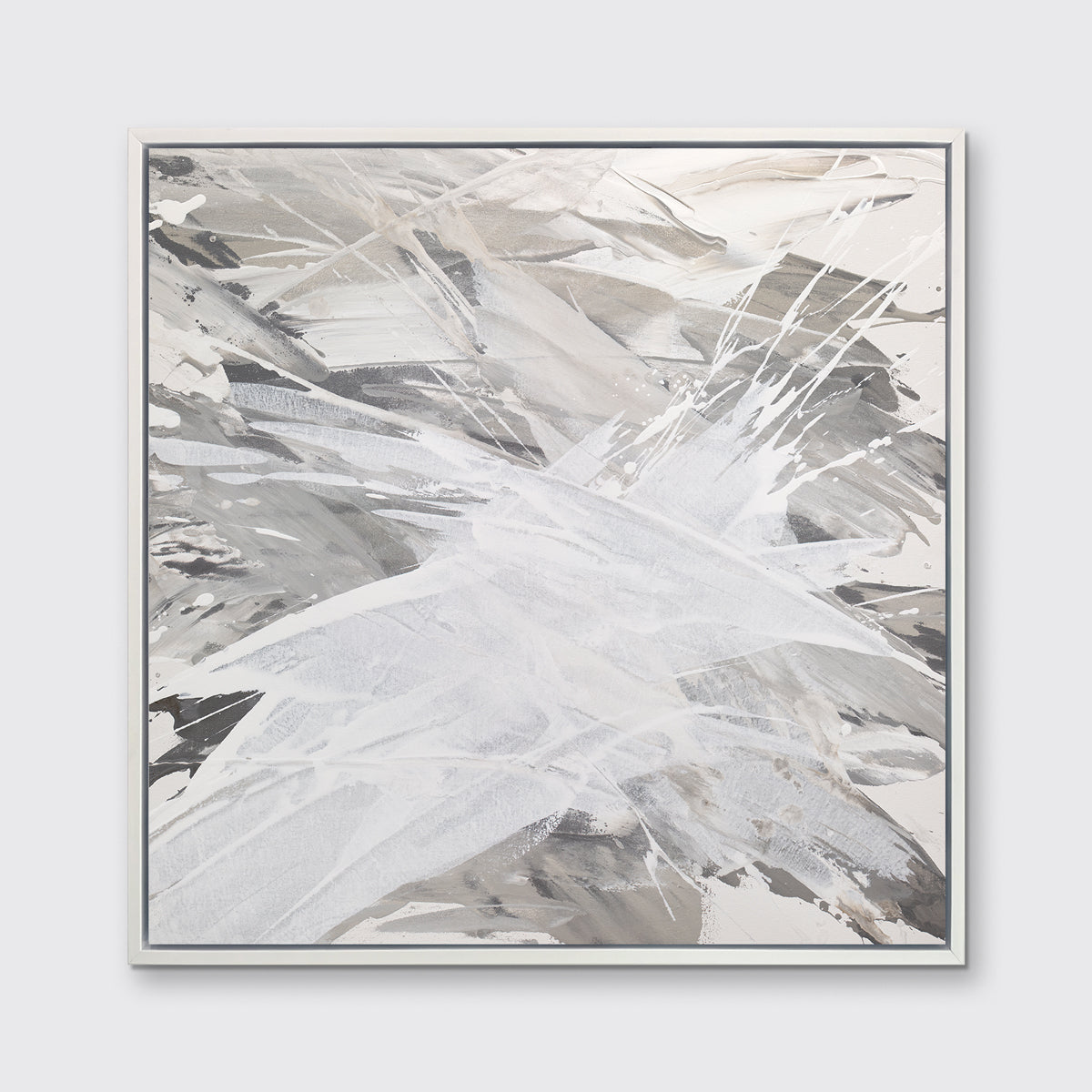 A grey, beige and white abstract print in a white floater frame hangs on a white wall.