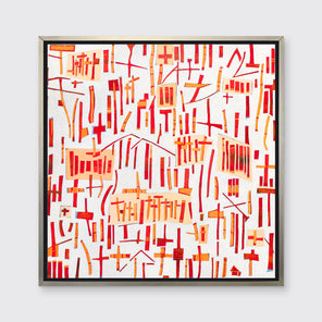A red, orange and white abstract print in a silver floater frame hangs on a white wall.