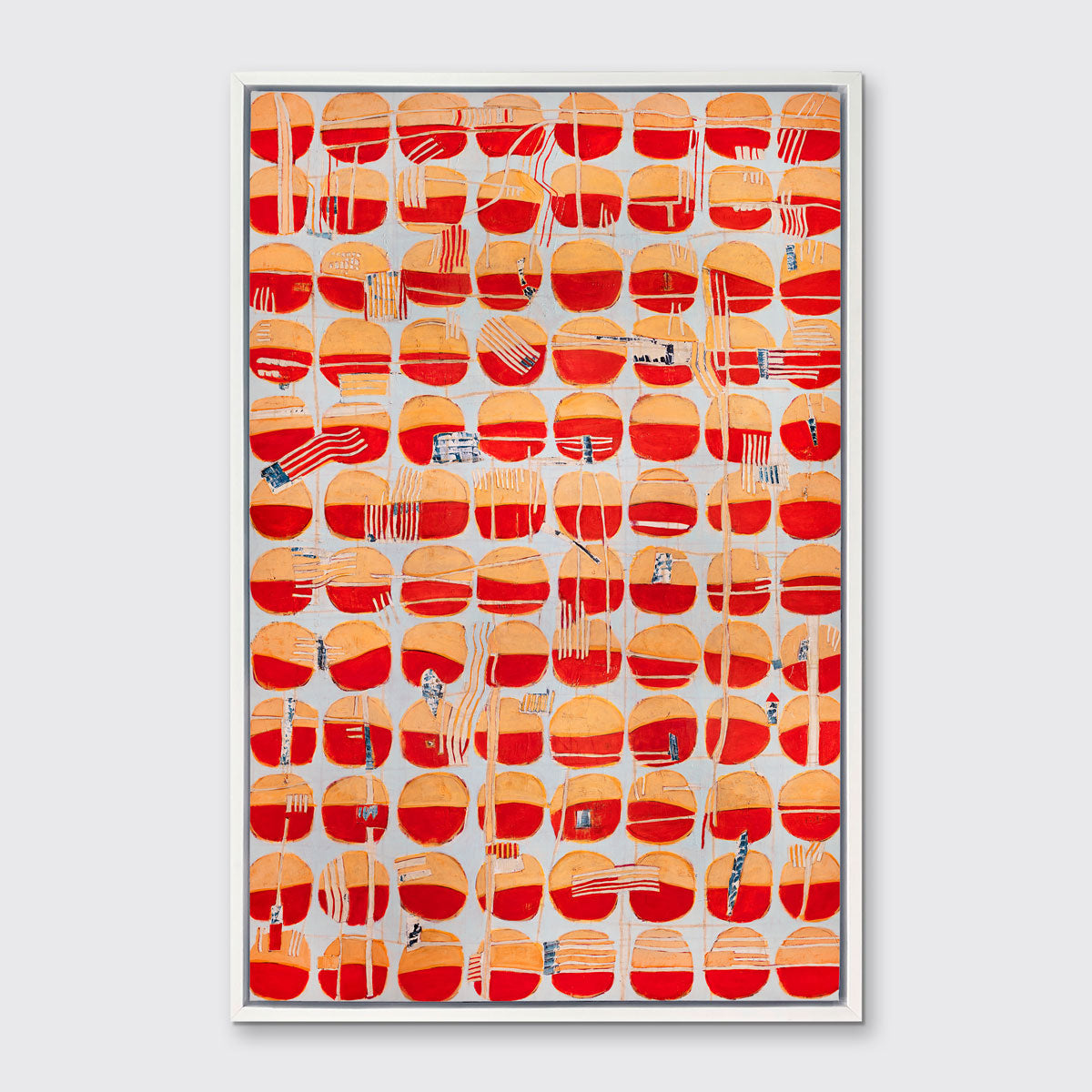 A red, orange and light blue abstract print in a white floater frame hangs on a white wall.