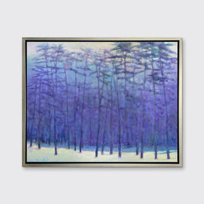 A blue, purple, light pink and soft yellow impressionistic landscape print in a silver floater frame hangs on a white wall.