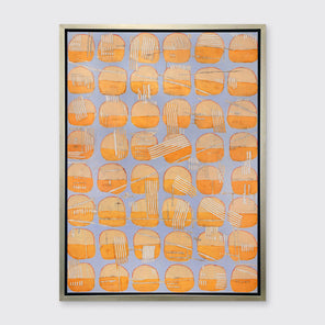 A orange and light purple abstract circle print in a silver floater frame hangs on a white wall.