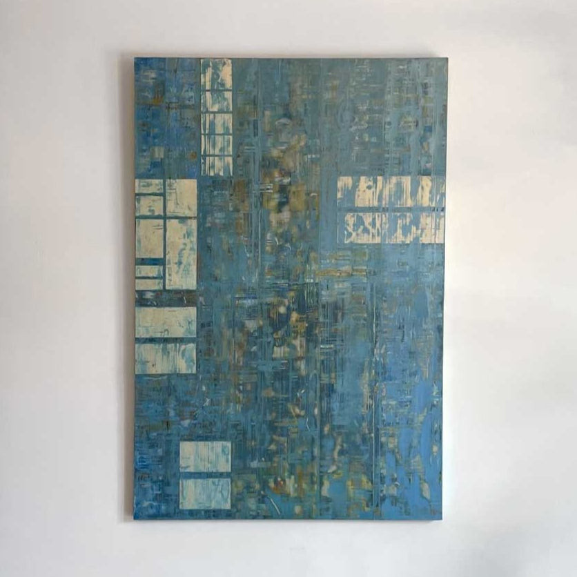 Mixed media abstract painting with small panels of aluminum and blue wash by Ned Martin hangs on a white wall with a view from straight on.