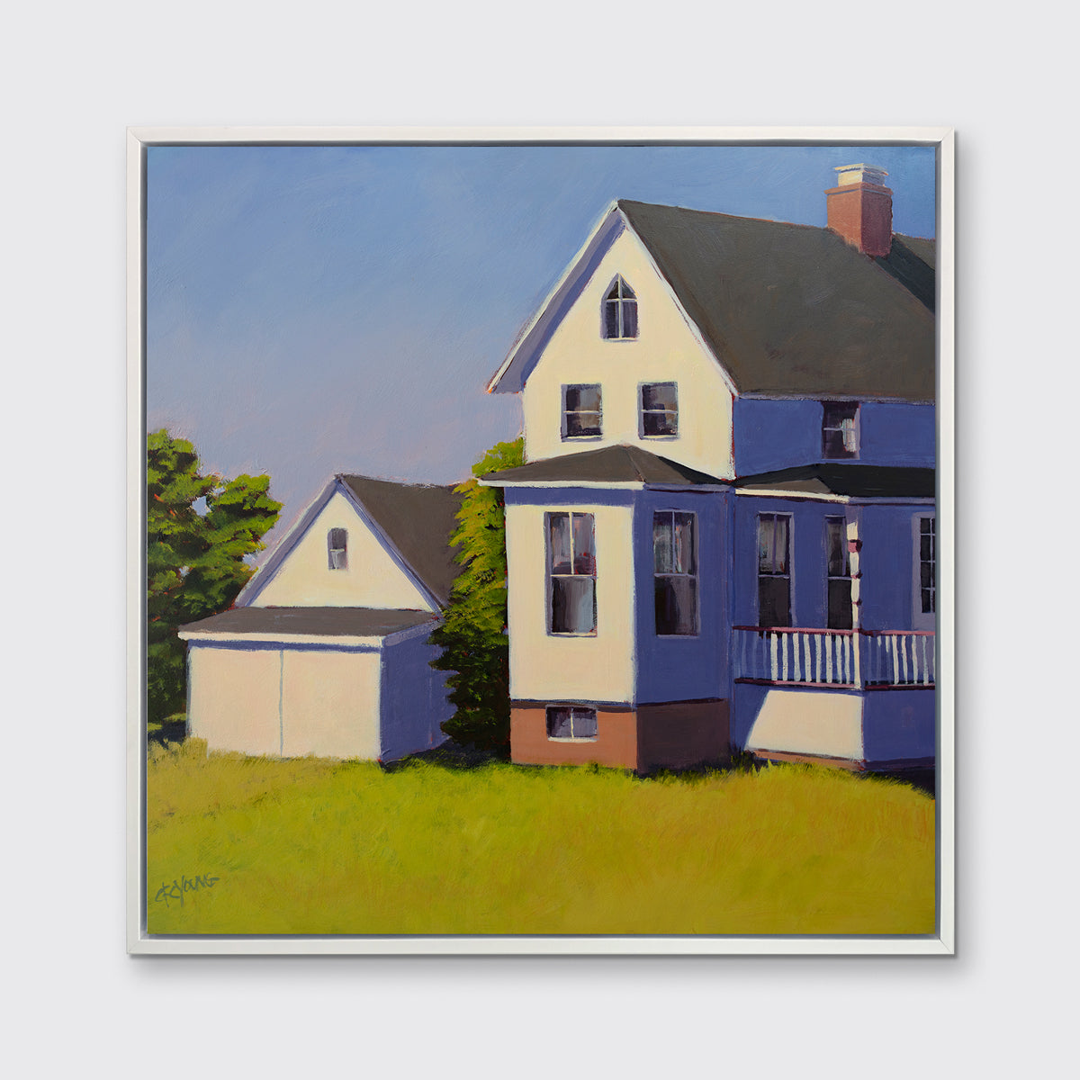 A blue, white and green contemporary house print in a white floater frame hangs on a white wall.