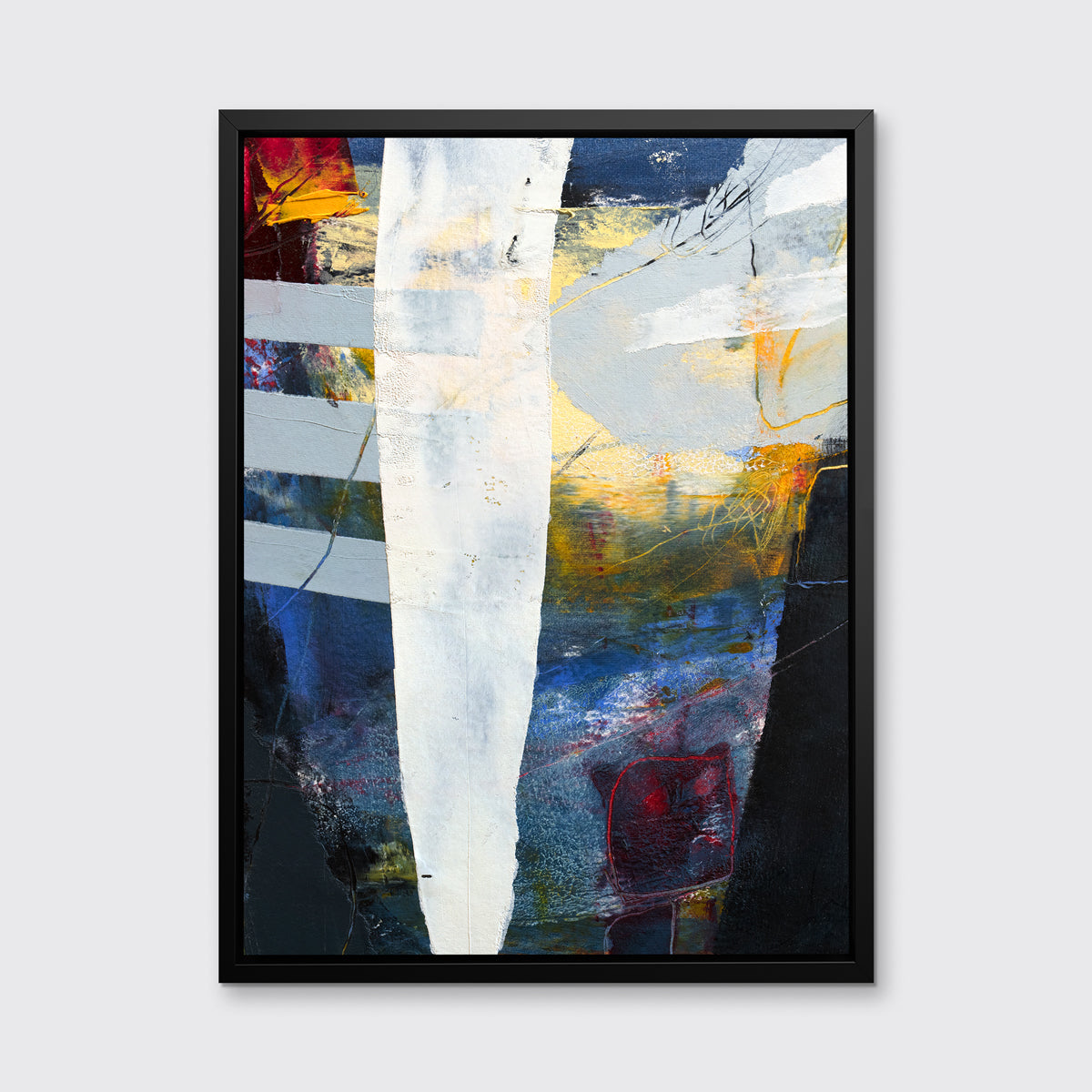 A white, yellow, red and grey abstract print in a black floater frame hangs on a white wall.