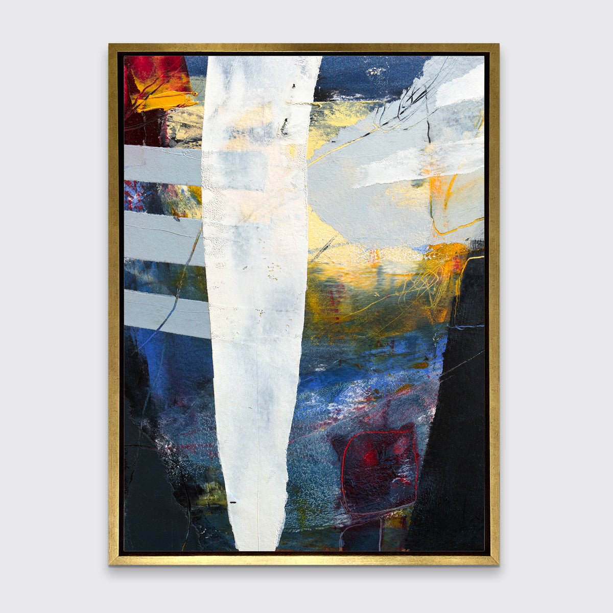 A white, yellow, red and grey abstract print in a gold floater frame hangs on a white wall.