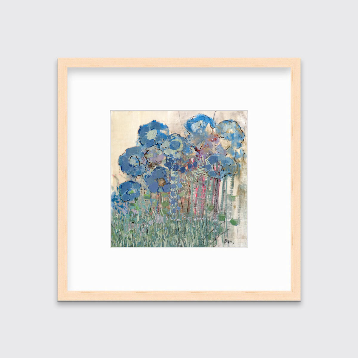 A blue and green abstract floral print in a natural wood frame with a mat hangs on a white wall.