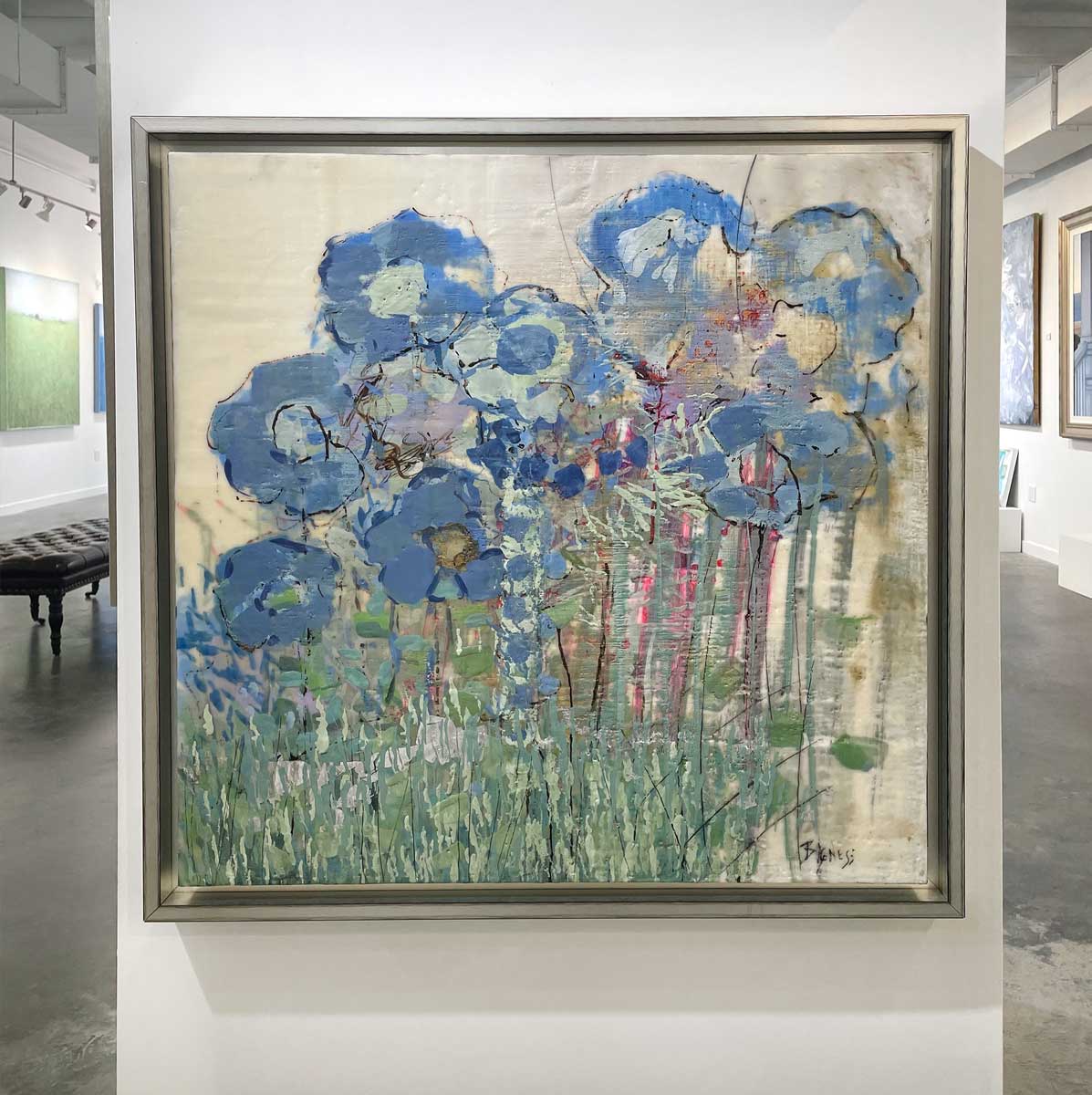 An abstract, encaustic floral painting of blue hydrangeas by Linda Bigness hangs on a white wall with a straight on view.