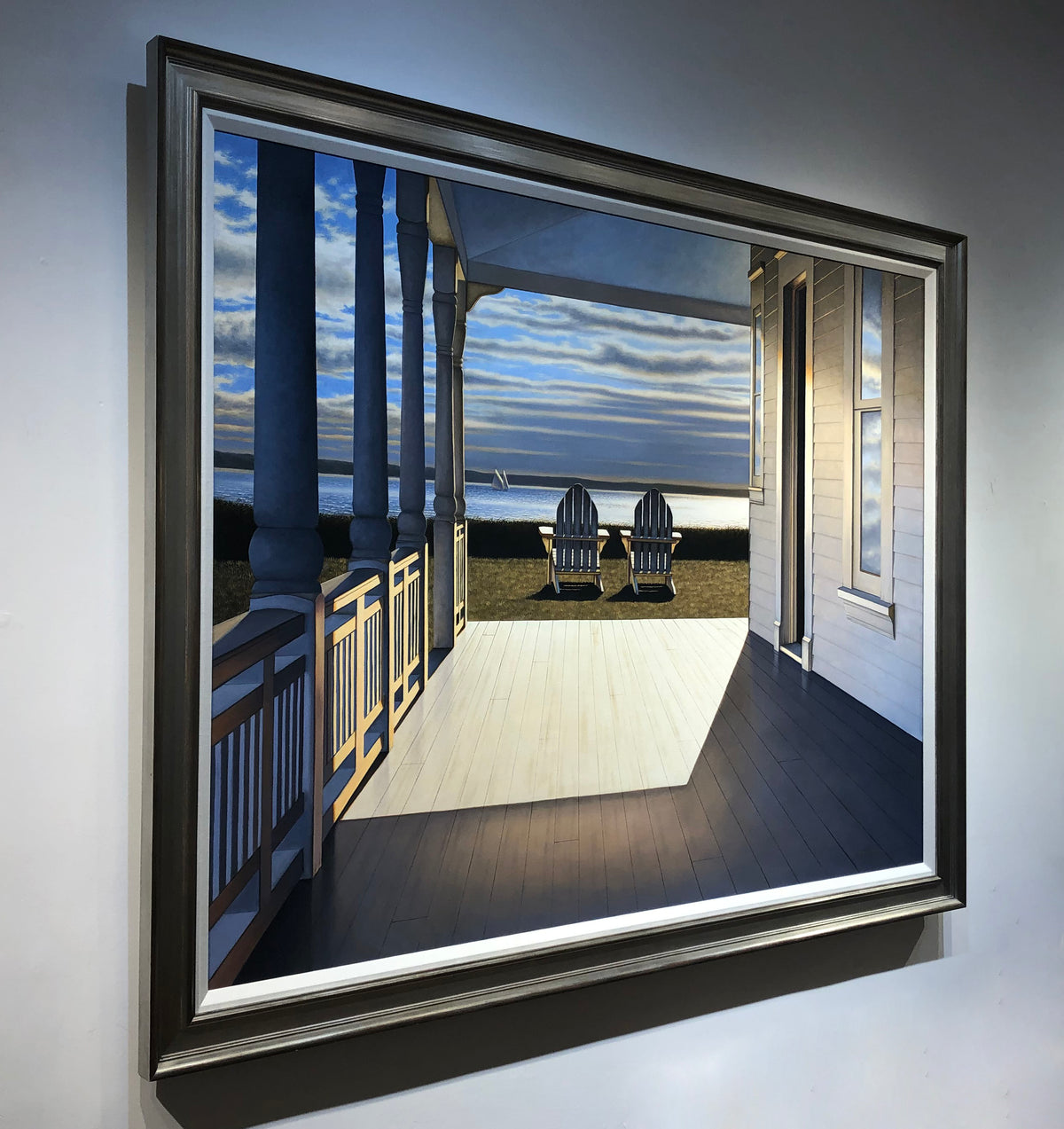 "Passing Time" framed and hung on a white wall. Photographed from the left side.