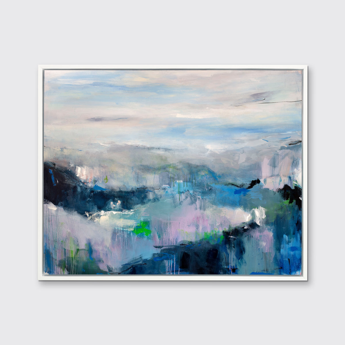 A blue, purple and green abstract print in a white floater frame hangs on a white wall.