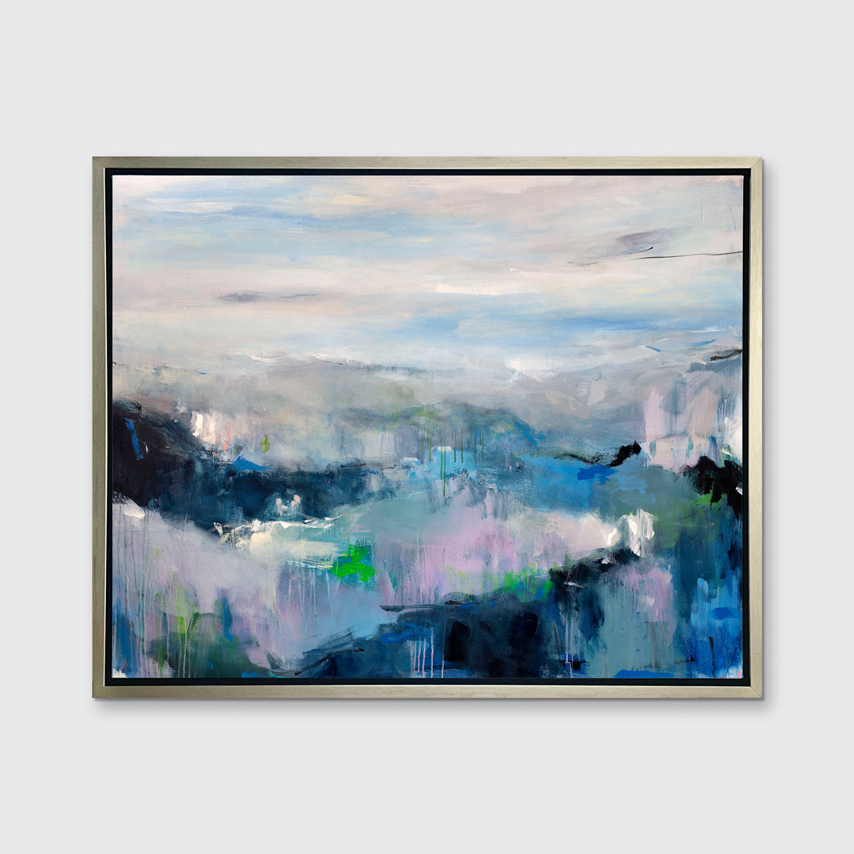 A blue, purple and green abstract print in a silver floater frame hangs on a white wall.